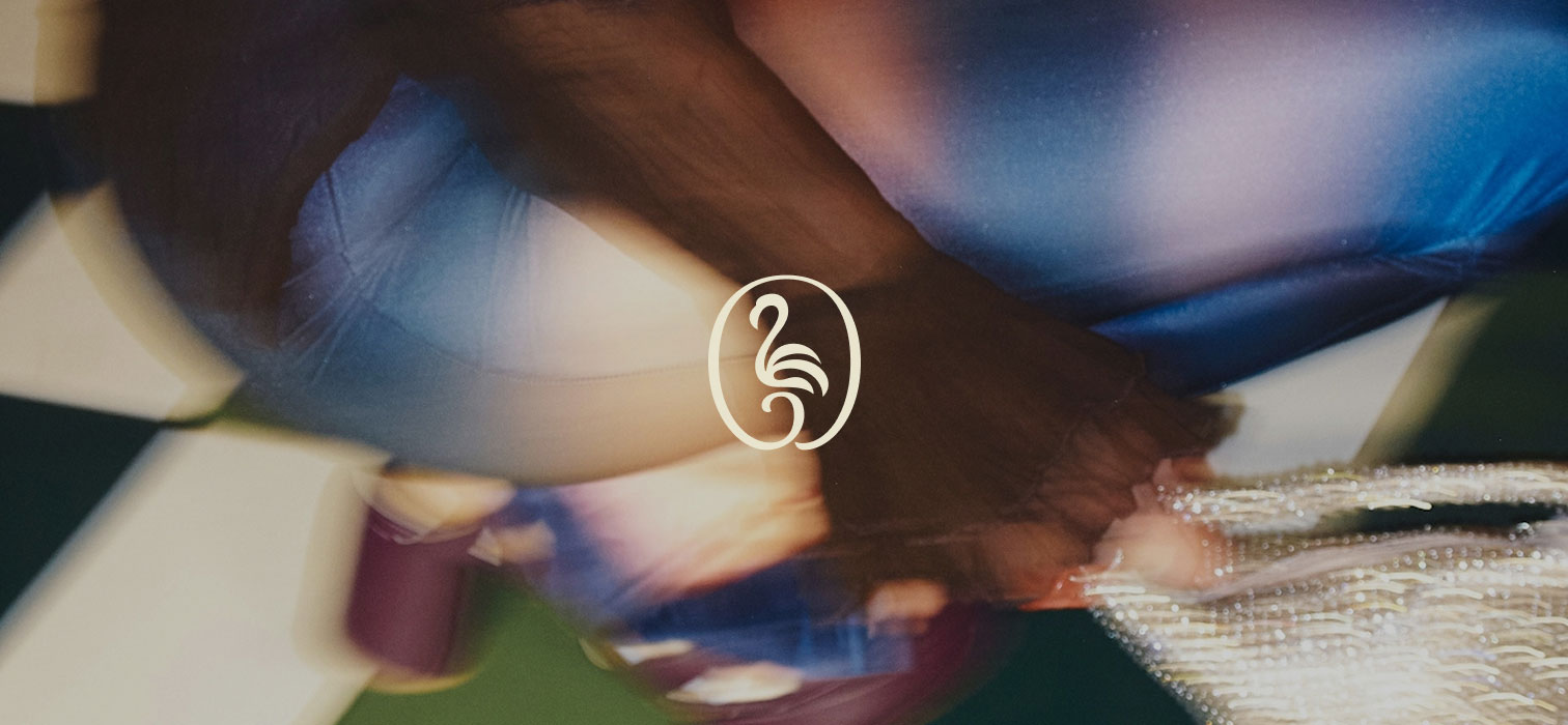 Crouching person with close up of right arm, jeans and shoe